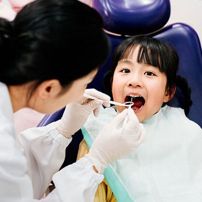 Experienced dentist treating a patient at Clear Dental